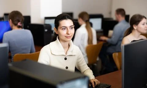 Female student at computers in university computer class Stock Photos