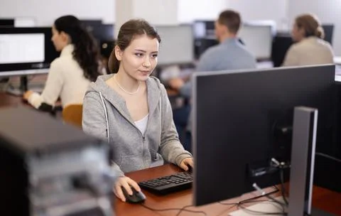 Female student at computers in university computer class Stock Photos