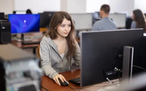 Female student at computers in university computer class Stock Photos