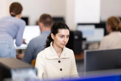 Female student at computers in university computer class Stock Photos