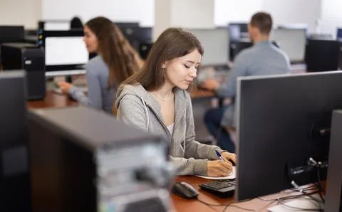 Female student at computers in university computer class Stock Photos