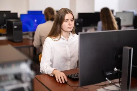 Female student at computers in university computer class Stock Photos