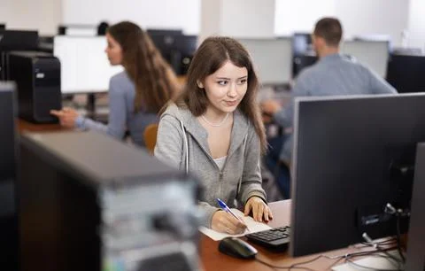 Female student at computers in university computer class Stock Photos