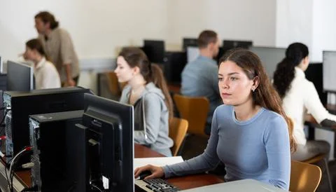 Female student at computers in university computer class Stock Photos