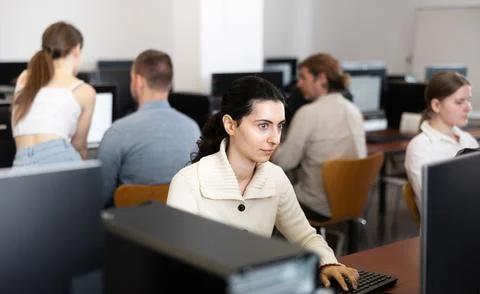 Female student at computers in university computer class Stock Photos