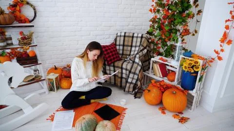 Female Student Doing Homework on Computer and Reads Information on Papers Lying Stock Photos