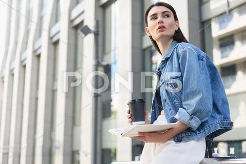 Female student drinking coffee outdoors Stock Photos