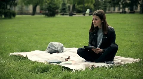 Female student e-learning outdoors at campus. Stock Footage 65335716