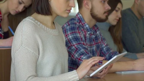 Female student flips on tablet 動画素材 73638065