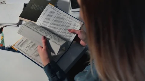 A female student flips through a book. Close-up. Stock Footage 82360833