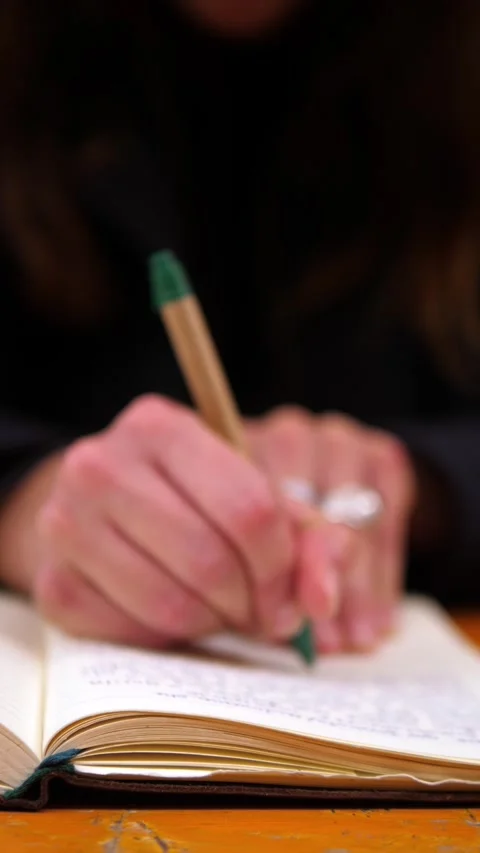 Female student hands taking notes in notebook during university lesson Stock Footage 334774960