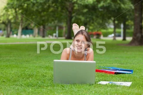 Female student with laptop and books at the park Stock Photos