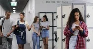 Female Student Looking At Smartphone In High School Corridor Stock Footage