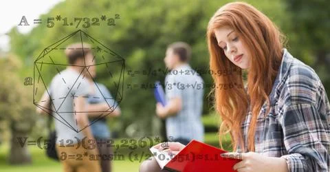 Female student reading book with math equations in foreground Stock Photos