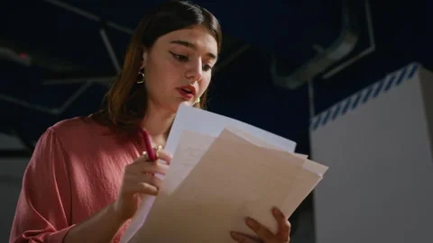 Female Student Reading Theater Script with Pen during Rehearsal Stock-Footage 344520368