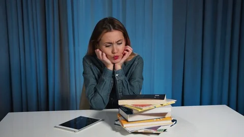 A female student rejects a stack of books and selects a tablet. A lot of work. Stock Footage 82360271