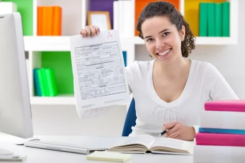 Female student showing perfect grade a plus. Stock Photos