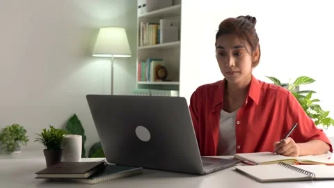 Female student sitting on desk study online on laptop take notes in notebook Stock Footage 168051501