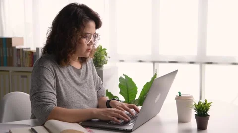 Female student sitting on desk study online on laptop take notes in notebook Video stock 169902870