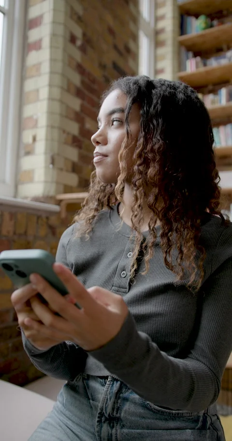 Female Student on Sofa using Phone Relaxing at Home Stock Footage 297293082