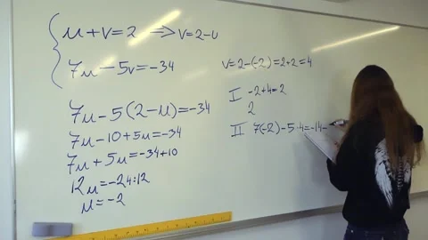 Female student solving algebra equation on whiteboard in a classroom Stock Footage 344105727
