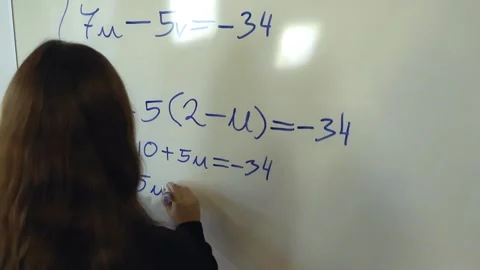 Female student solving a math problem on a whiteboard Stock Footage 344104932
