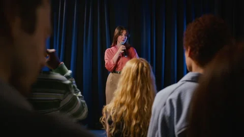 Female Student Speaking into Microphone on Stage in Front of Audience Stock Footage 344531606
