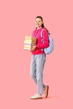 Female student with stack of books on pink background Stock Photos