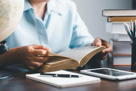 Female student study in the school library. She using laptop and learning o.. Stock Photos