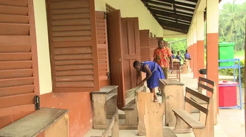 FEMALE STUDENT SWEEPS OUTSIDE OF A CLASSROOM Stock Footage 60116221