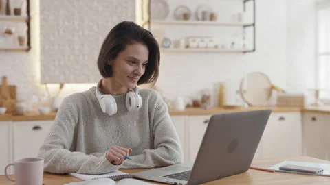 Female student taking notes during video lesson on laptop Video stock 154696540
