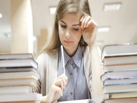 Female student thinking with note pad. Stock Footage 82200834