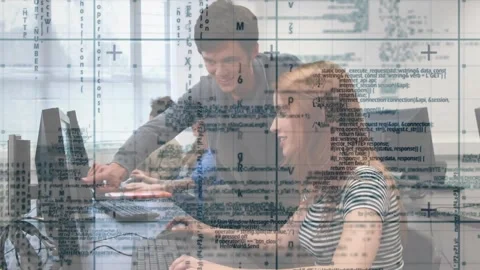 Female student typing in tech lab, male tutor pointing at monitor, guiding Stock Footage 321783318