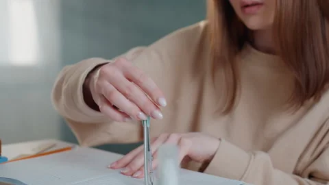 Female student uses compass for accurate drawing. Young woman in casual attire Stock Footage 336866212