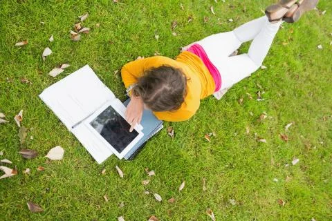 Female student using tablet PC in the lawn Stockfoto's
