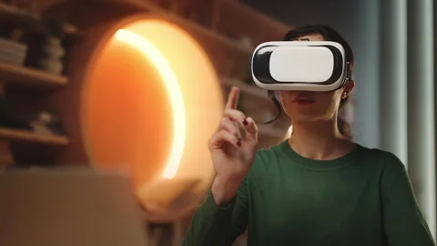 Female student using VR headset for immersive learning experience in library Stock Footage 340961923