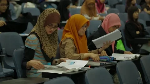 Female Students Browsing Through Textbook In Class Stock Footage 49387509