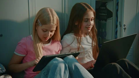 Female Students Collaborate on STEM Project Using Laptop and Tablet in Middle Stock Footage 342027475