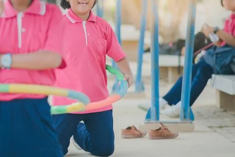 Female students doing exercise with a hula-hoop for a good healt Stock Photos
