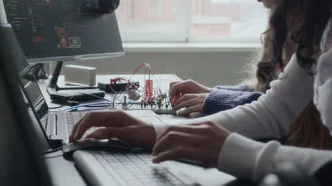 Female Students Using Computer while Working on Electronic Project in Class Stock Footage 284436728