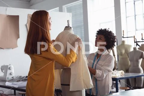 Female students working on a garment at a fashion college Stock Photos