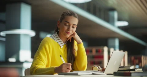 Female Studying on Laptop Computer in Library Stock Footage 256039217