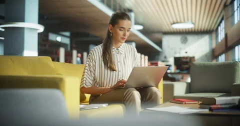 Female Studying on Laptop Computer in Library Stock Footage 256040105
