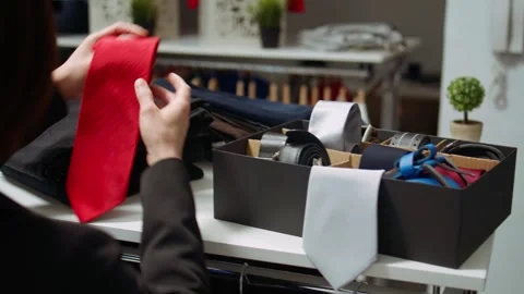 Female stylist mall worker sorting the new collection of accessories Stock Footage 319530774