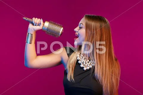 Female stylist standing with hairdresser's accessories Stock Photos