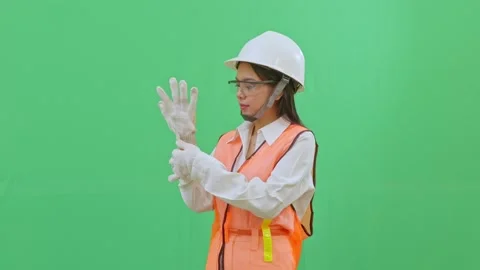 Female supervisor putting on her left safety glove Stock-Footage 332057291
