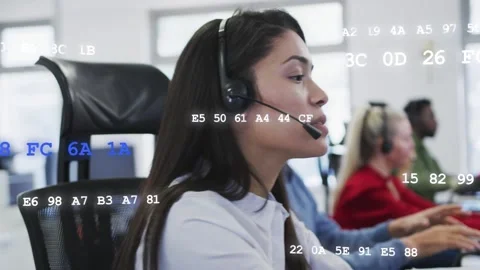 Female support agent answering call, tuning headset, speaking as data overlays Stock Footage 333575558