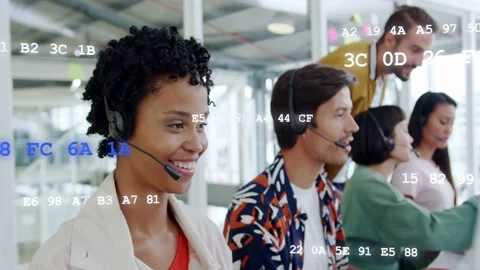 Female support agent answering incoming call using headset while hex codes Stock Footage 333602235