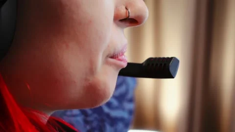 Female support agent working remotely wearing headset microphone near lips and Stock Footage 343952089