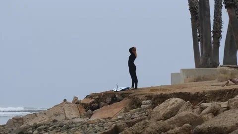 Female surfer getting ready to hit the waves Stock Footage 155010559
